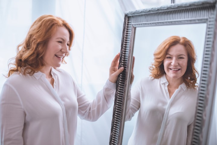 Mujer mirándose al espejo durante la menopausia